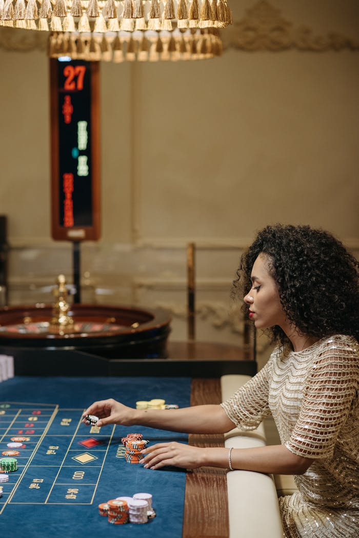 Stylish woman placing bets at a casino roulette table, focused and elegant.